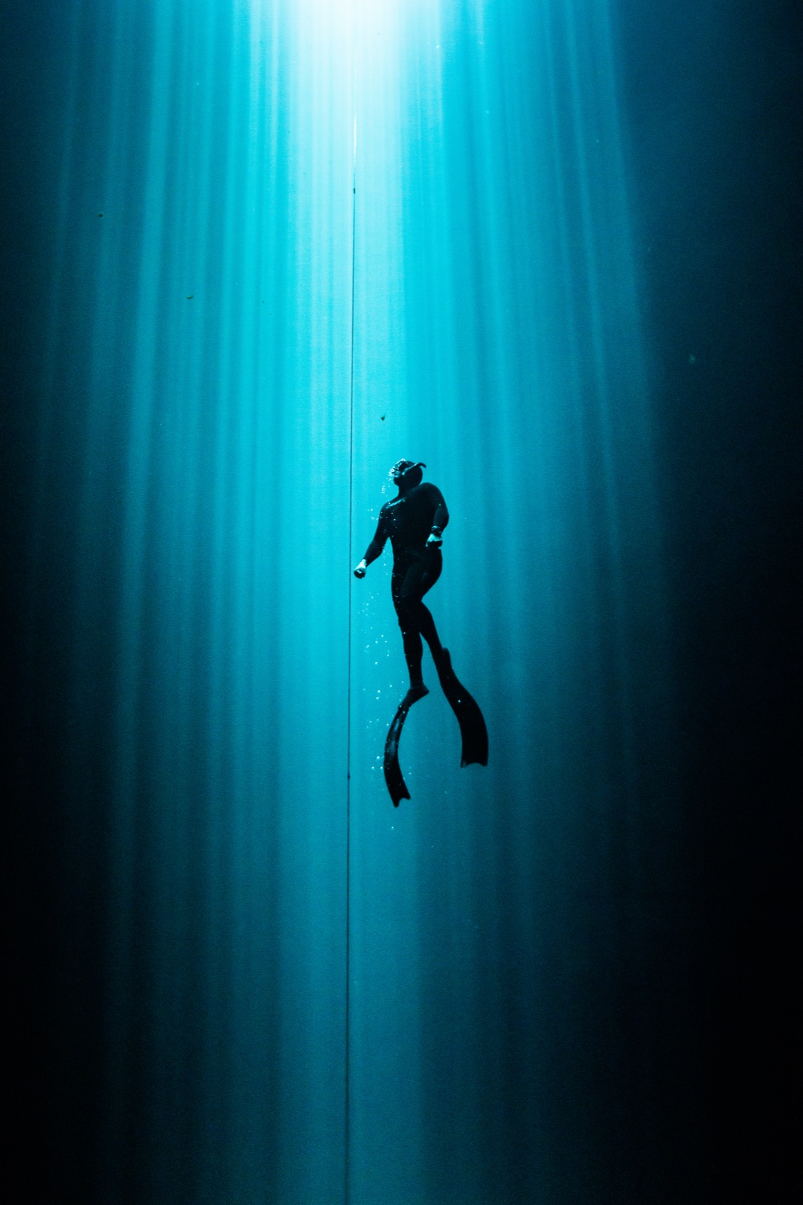 Richard Bargas freediving toward the surface light on a single breath